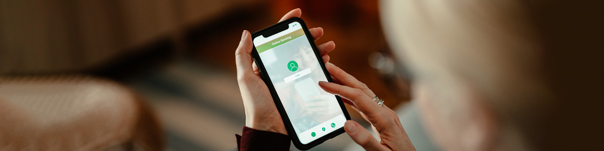 woman signing in to online banking on phone